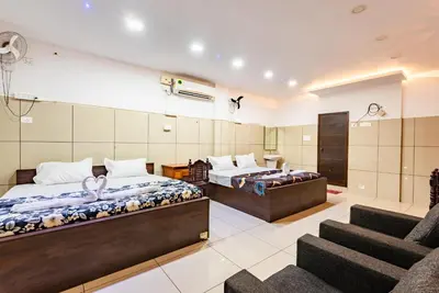 a hotel room with two beds and a staircase at Oxe residency in Kozhikode