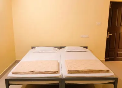 a bed in a room with two pillows on it at Villa 9 degrees north in Sultan Bathery