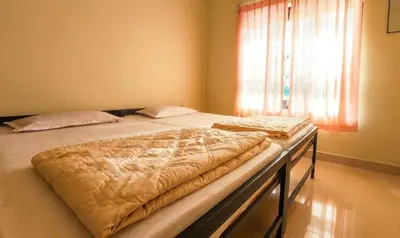 a large bed in a bedroom with a window at Villa 9 degrees north in Sultan Bathery