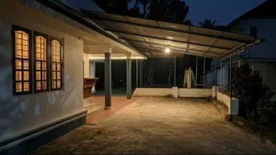 an empty patio of a house at night at Villa 9 degrees north in Sultan Bathery