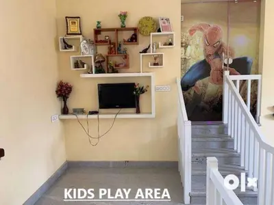 a kids play area with a tv and stairs at Charis Villa in Kunnamkulam near Guruvayoor in Kunnamkulam