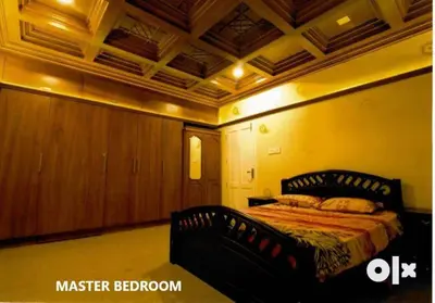 a bedroom with a bed in a room at Charis Villa in Kunnamkulam near Guruvayoor in Kunnamkulam