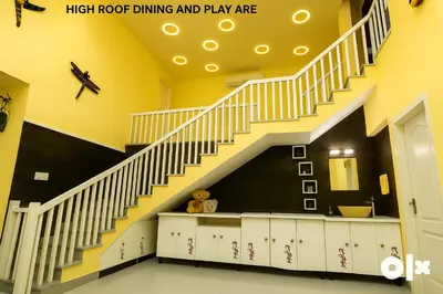 a staircase in a room with yellow walls at Charis Villa in Kunnamkulam near Guruvayoor in Kunnamkulam