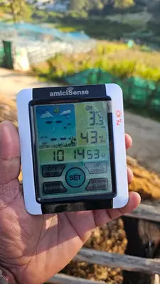 a person holding a smart phone in their hand at Bluehood WildScape in Vattavada