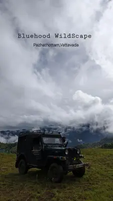 a black jeep parked in a grass field at Bluehood WildScape in Vattavada