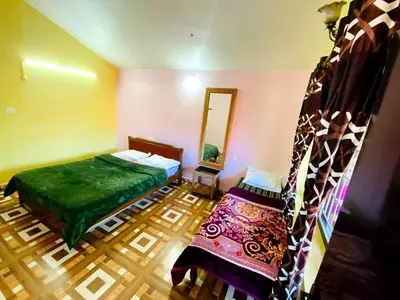 a bedroom with a bed and a mirror and a staircase at Skyline Haven cottage in Ooty