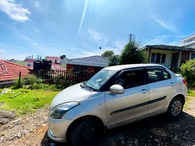 a small white car parked in front of a house at Skyline Haven cottage in Ooty