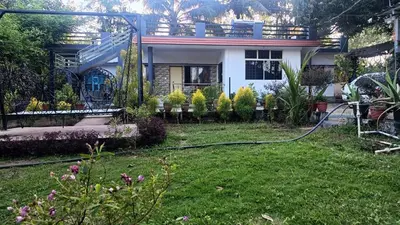 a house with a hose in a yard at Manna Homestay coorg in Kushālnagar