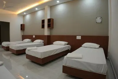 a room with three beds in a room at SK Premium Residency in Edakkara