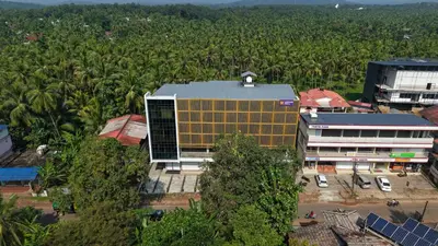 an overhead view of a building with a bunch of palm trees at SK Premium Residency in Edakkara