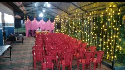 a room filled with red chairs and lights at Morning mist holidays Thusharagiri in Vallikavungal