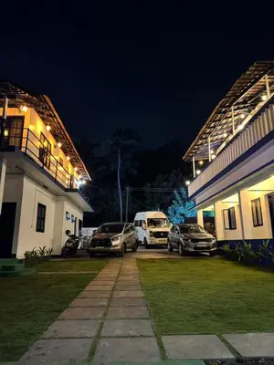 a group of cars parked outside a building at night at Kadale Boutique Beach Stay in Kannur