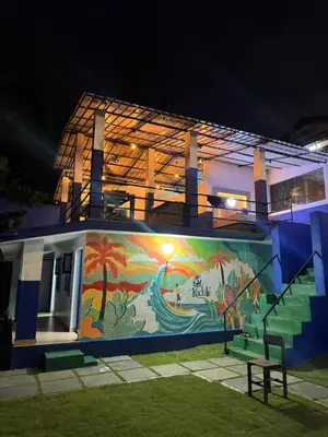 a building with a mural on the side of it at Kadale Boutique Beach Stay in Kannur
