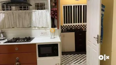 a kitchen with a sink and a stove top oven at Charis Villa and Guest house 5bed 4bath in kunnamkulam in Kunnamkulam
