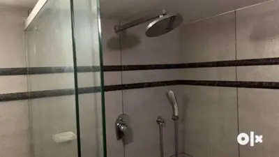 a shower with a glass door in a bathroom at Charis Villa and Guest house 5bed 4bath in kunnamkulam in Kunnamkulam