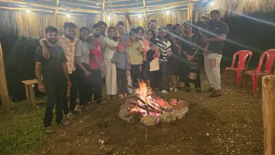 a group of people standing around a fire at Daddy's MAD house in Kottakamboor