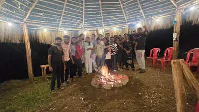 a group of people standing around a fire at Daddy's MAD house in Kottakamboor