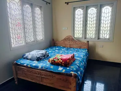 a bed with two pillows on it in a room at PG For Men in Mysore