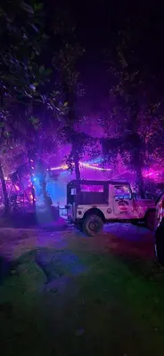a white truck parked in a field at night at Happy Feet Wayanad in Vaduvanchal