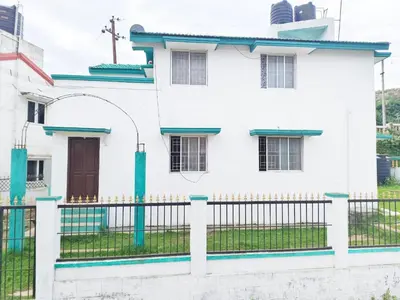 a white house with a fence and a door at Greenland 2bed room hall villa in Ooty
