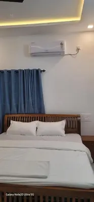a bedroom with a bed with a blue curtain at The Paul Residence