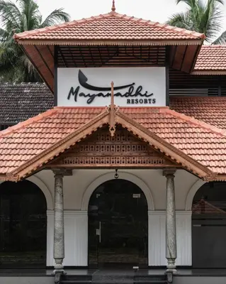 a building with a mosque sign on top of it at Mayanadhi Resort in Irimbranallūr