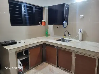 a kitchen with a sink and a counter top at Home stay in Manjeri