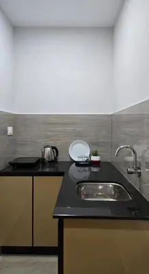 a kitchen with a sink and a counter top at Munderi Green Mounts - Family Rooms with Swimming Pool in Kalpetta