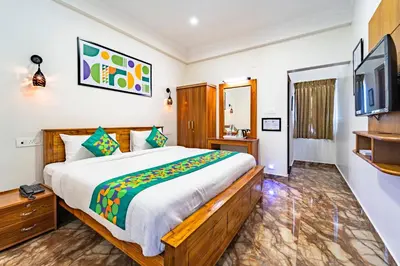 a bedroom with a large bed and a tv at Treebo Lumino Crown, 850 Meters From Ooty Lake in Ooty
