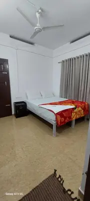 a bedroom with a bed in a room at Hill valley farm resort in Viripara
