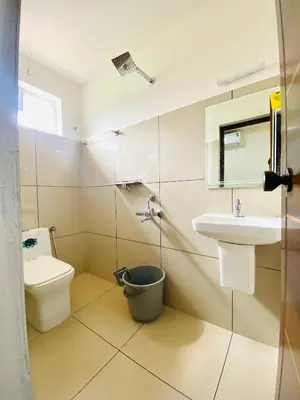 a bathroom with a sink and a toilet at Metro Residency in Perintalmanna