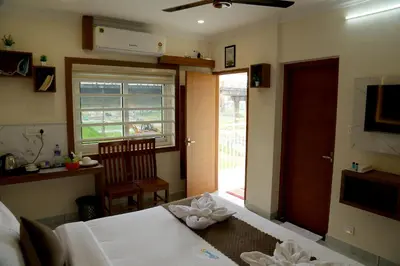 a bedroom with a bed and a door to a patio at Cloud9 Airport Hotel in Nedumbassery