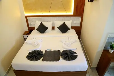 a bedroom with a bed with two towels on it at Cloud9 Airport Hotel in Nedumbassery
