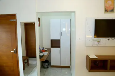 a room with a television and a white cabinet at Cloud9 Airport Hotel in Nedumbassery