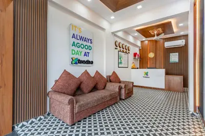 a living room with a couch in a lobby at Treebo Adithi Comforts Inn And Suites in Mysore
