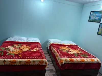 two beds sitting next to each other in a room at BN HOMESTAY be nature in Devikolam