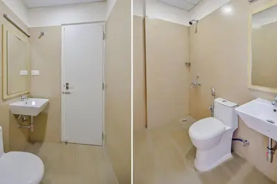 a bathroom with a toilet and a sink and a shower at capital o hotel paradise international in Coimbatore
