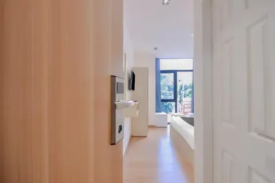 a room with a hallway with a door and a window at capital o hotel paradise international in Coimbatore