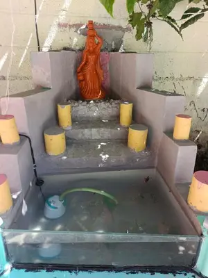 a model of a bath tub with a statue in it at JK Cottages in Suntikoppa