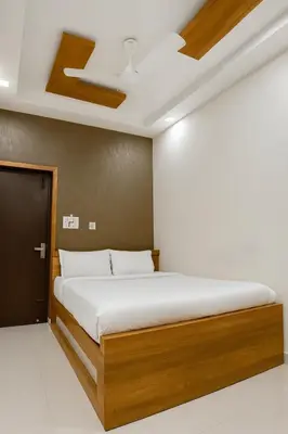 a bedroom with a bed in a room at MK Residency Calicut near Baby Memorial Hospital in Kozhikode
