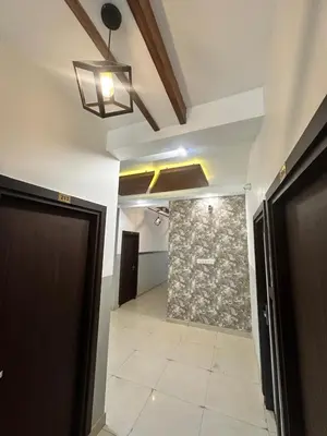 a hallway with a tile floor and a ceiling at MK Residency Calicut near Baby Memorial Hospital in Kozhikode