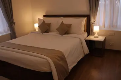 a bedroom with a large bed with white sheets and pillows at Memories at The Blue Mountains in Kotagiri