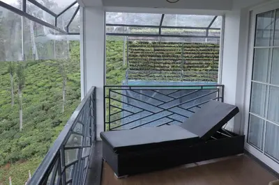 a balcony with a bench in front of a window at Memories at The Blue Mountains in Kotagiri