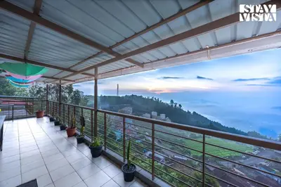 a balcony with a view of the mountains at Mistydawn Villas By Sunset Valley by VEO - Part of StayVista in Ooty