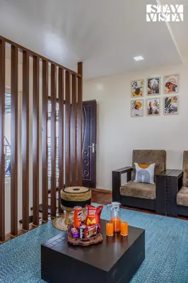 a living room with a coffee table with orange juice at Mistydawn Villas By Sunset Valley by VEO - Part of StayVista in Ooty
