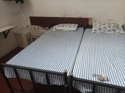 a bed with a pair of keys on top of it at chenniyappa lodge in Chennimalai