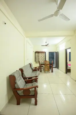 a living room with two chairs and a table at Skybz Resort - Mankulam in Viripara