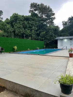 a swimming pool in the backyard of a house at Skybz Resort - Mankulam in Viripara