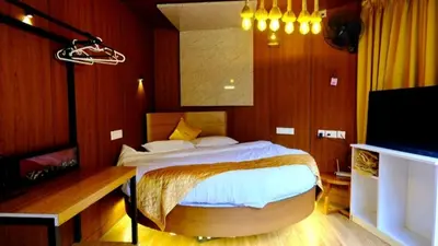 a bedroom with a bed and a tv in it at Zeno Village Resort 900 Kandi Wayanad in Wayanad