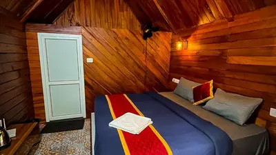 a bedroom with a bed in a wooden cabin at Zeno Village Resort 900 Kandi Wayanad in Wayanad